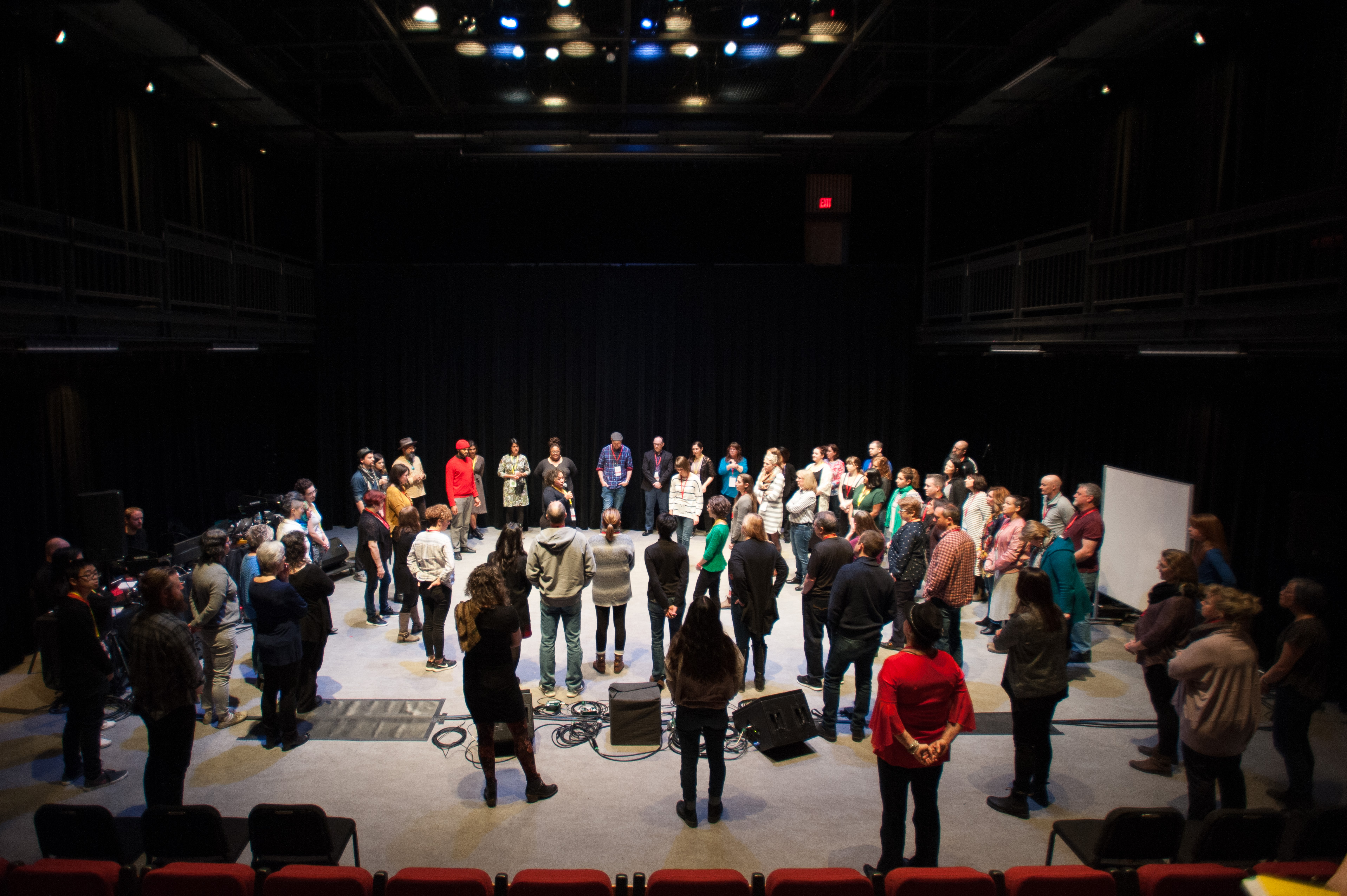 Educators stand in a circle onstage while attending Showcase
