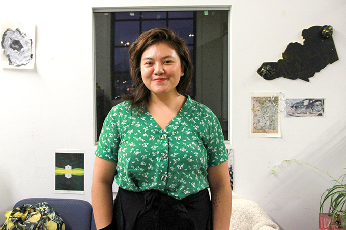 Faune Ybarra ArtStarts artist in residence stands in the ArtStarts Maker Space