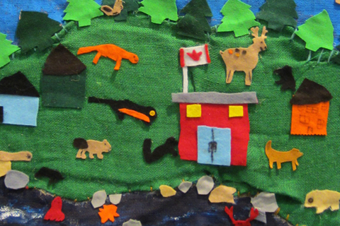 A collage made of felt features animals, a house, and Canadian flag