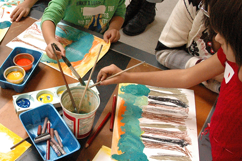 A group of young learners painting